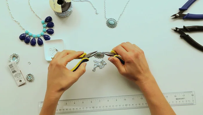 Cut the chain in the center and attach the clasp using jump rings.