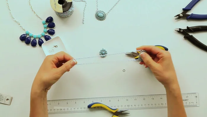 Cut the chain in the center and attach the clasp using jump rings.