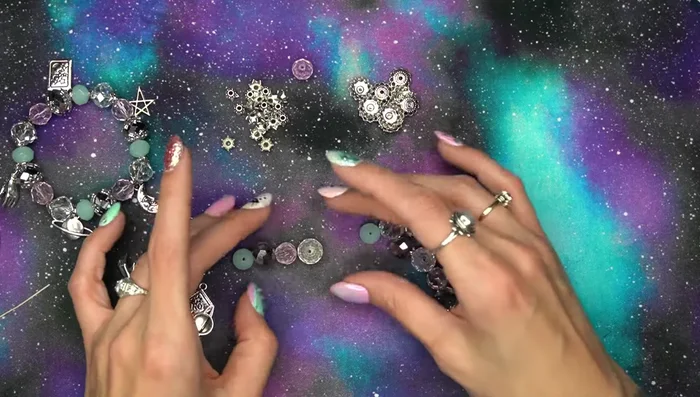 Arrange beads and bead caps in a desired pattern. The tutorial uses a staggered color pattern.