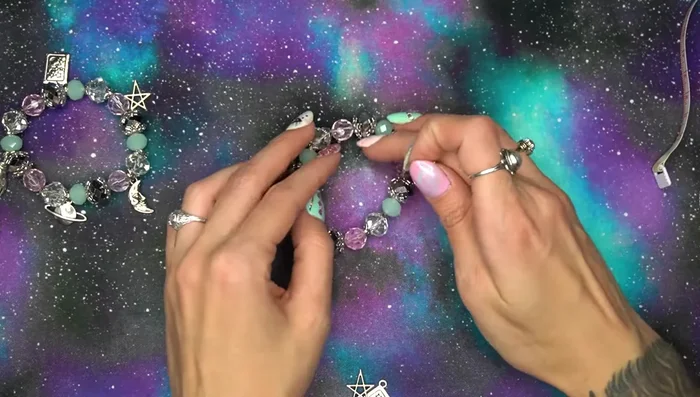 Repeat step 6 for all charms, placing them at even intervals (every 3 beads in this example).