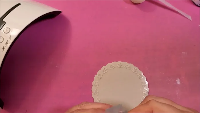 Remove the tape. Attach the ring to a glass panel or tile using sticky tack. Add a final layer of resin to dome the top and cure for 3 minutes.