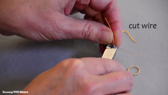 Cut the excess wire and use chain nose pliers to tighten the wraps.