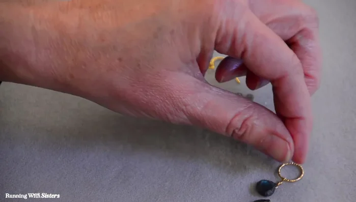 Attach a labradorite rondelle to a head pin, creating a loop at the top.