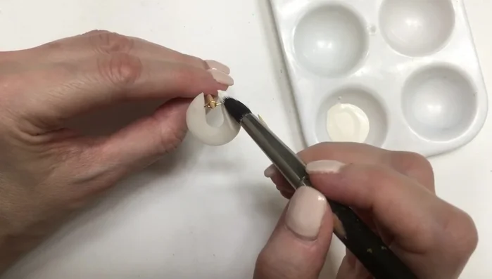 Attach ear wires to the eye pins using pliers.