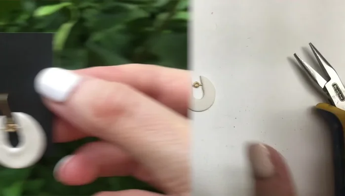 Attach ear wires to the eye pins using pliers.