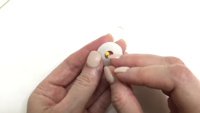 Use an exacto knife to cut two straight lines to create the earring hoops.