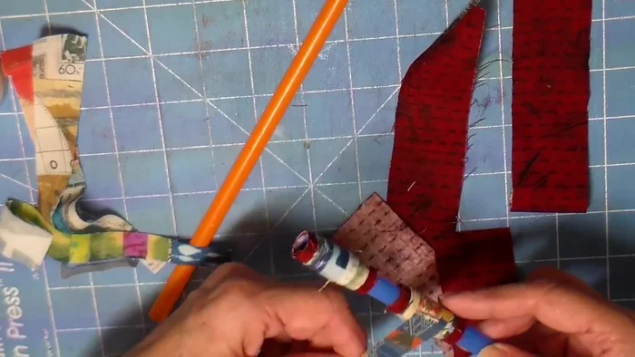 Add second fabric piece: Wrap a second fabric piece around the straw, slightly offset from the first. Glue the ends.