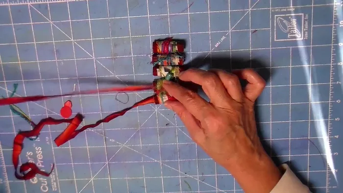 Attach necklace cord: Use a bodkin to thread silk ribbon (or other cord) through the beads and create a necklace loop. Zigzag the ribbon through the beads for added security.