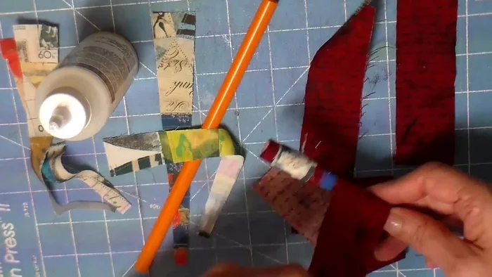 Add second fabric piece: Wrap a second fabric piece around the straw, slightly offset from the first. Glue the ends.