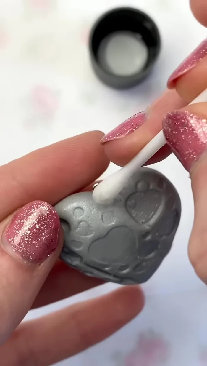 Clean the clay with a Q-tip dipped in nail polish remover to remove dust and debris.