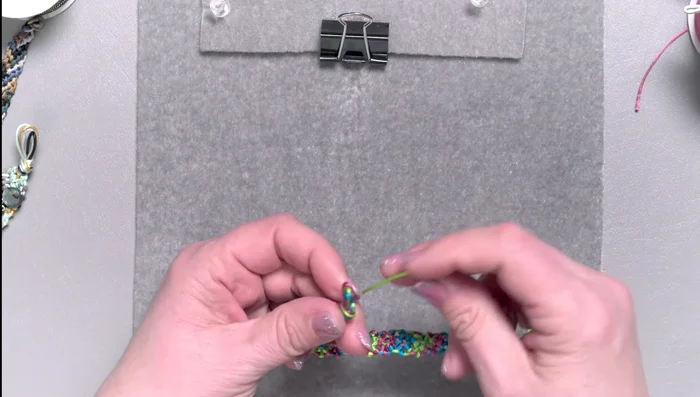 Thread one or two cords through the loops at the other end and tie to secure the bracelet.