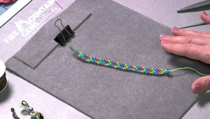 Attach the knot to a clipboard or other flat surface.
