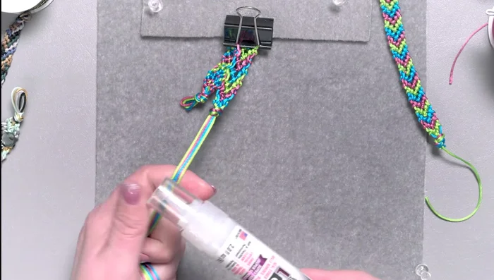 Thread one or two cords through the loops at the other end and tie to secure the bracelet.