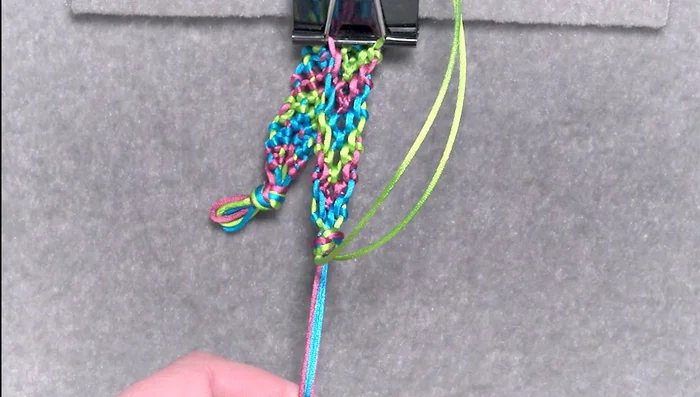 Thread one or two cords through the loops at the other end and tie to secure the bracelet.