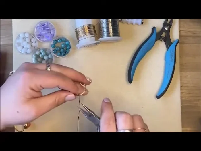 Prepare for the gemstone: Create a 90-degree angle from the ring band, then another 90-degree angle through the gemstone hole to position the bead.