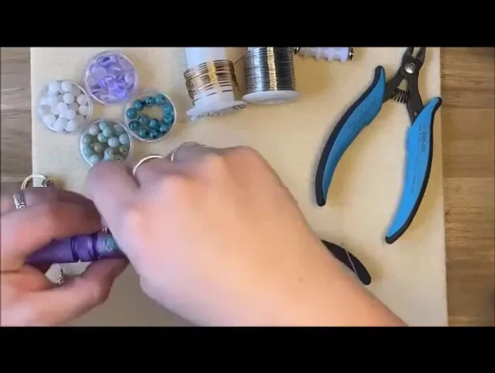 Wrap and secure: Wrap the wire around the base of the bead, ensuring the wires are fully covered. Make several loops on the side to fully secure the bead.