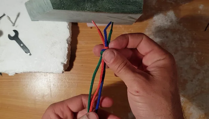 Secure one end of the braid using a weight or clip to keep it taut.