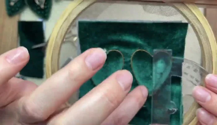 Attach the 6mm beads to the center of each heart.