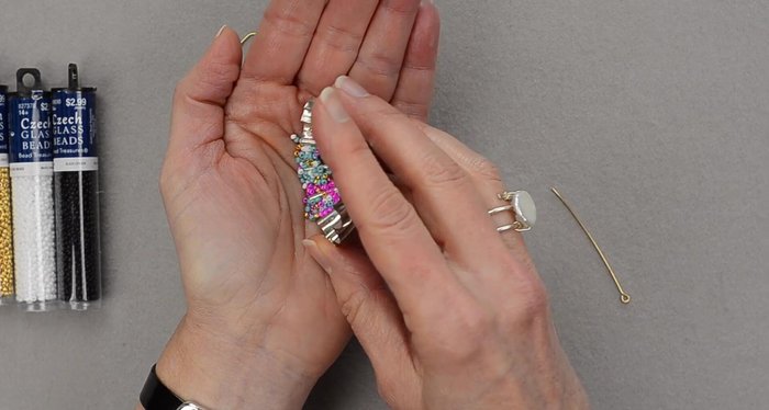 Prepare seed beads: Place a few of each color in your palm for easier handling.