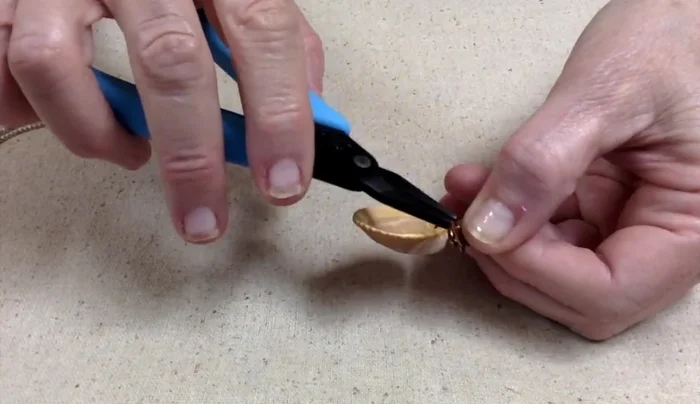 Adjust the bail to ensure the seashell hangs correctly when placed on a chain or earring finding. It should hang straight, not sideways.