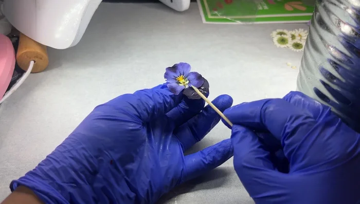 Remove excess silica gel from the dried flowers.