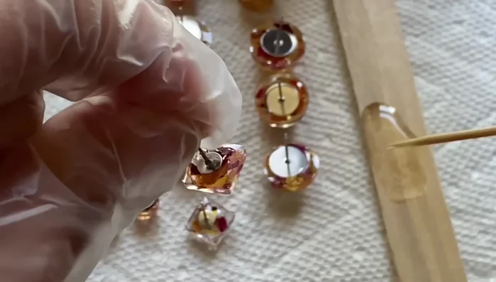 Attach jump rings to the studs and then add earring hooks. Cure with UV light for 4-5 minutes.