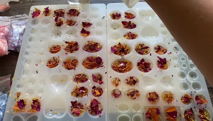 Add more clear resin on top of the flowers, pushing them down to prevent sharp edges.