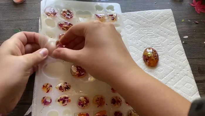 De-mold the earrings. Trim any excess resin with scissors.