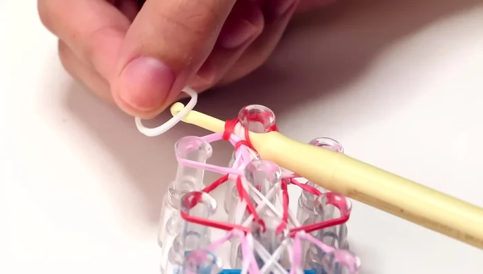Removing from loom: Use a hook and white band to carefully remove the bracelet from the loom.