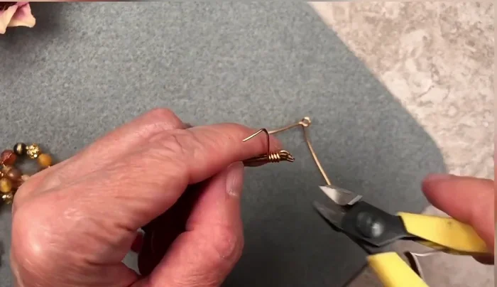 Carefully use flush cutters to remove excess wire, leaving a clean finish. Push the remaining wire end into the wraps.