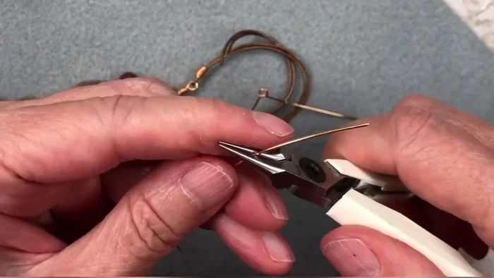 Repeat steps 2 and 3 for the second wire piece, ensuring both loops are identical.