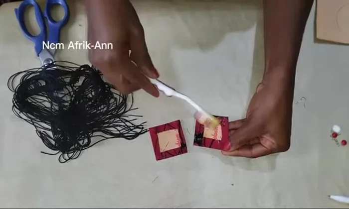 Attach the fringes to the fabric-covered strawboard.