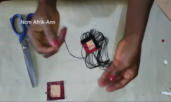 Sew the hook securely by repeatedly passing the needle through the bead and fabric.