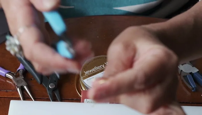 Cut the wire in the middle to create two separate ends.