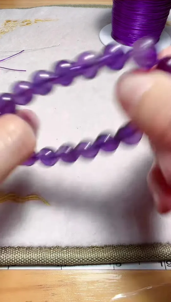 Hide the knot in the hole of the bracelet.