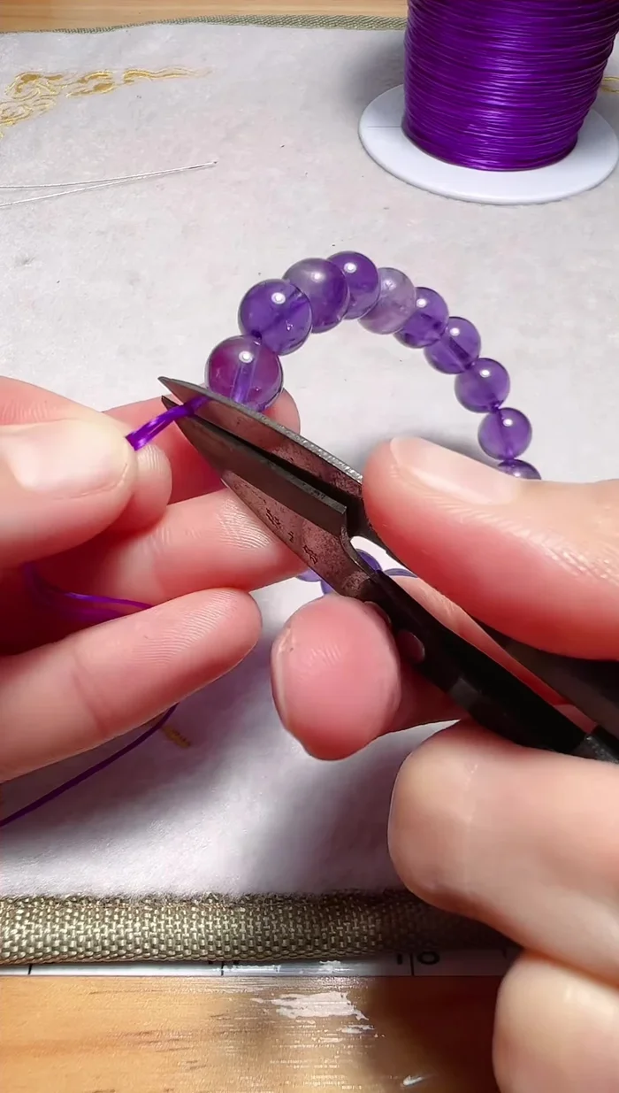 Hide the knot in the hole of the bracelet.