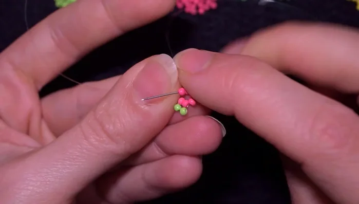 Reinforce the circle. Go through one pink bead, then a yellow bead, and then through the opposite pink bead (counting one, two, three from the first pink bead).