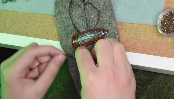 Finish the top wings with sequins, mirroring the bottom wing technique.