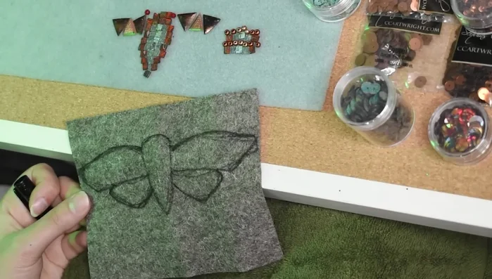 Prepare the felt base and sketch the cicada shape.