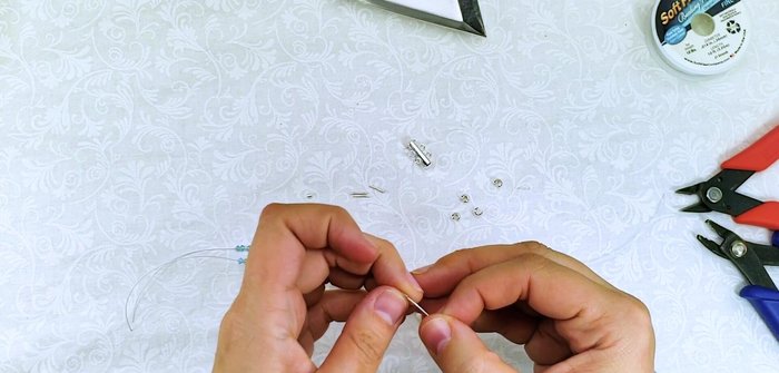 Trim and secure the wire: Trim excess wire leaving a small tail. Slide the first few beads onto the tail to cover the wire end.