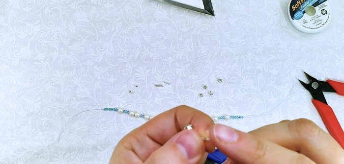 Trim and secure the wire: Trim excess wire leaving a small tail. Slide the first few beads onto the tail to cover the wire end.