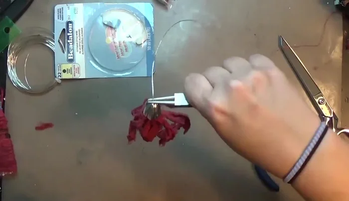 Trim the excess wire and secure the end with chain nose pliers.