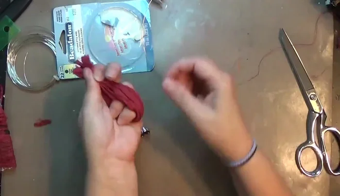 Twist the excess wire at the top and trim it using wire cutters. Secure the end with pliers.