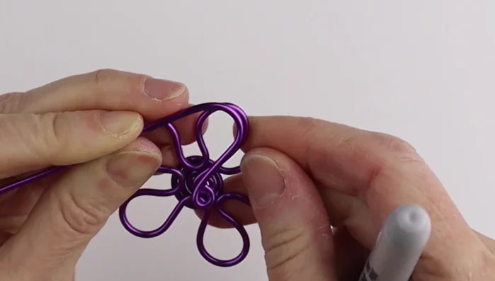 Assemble the flower: Bring all petals together, adjusting their positions. Secure using a ring cone to twist the wire several times, cut and tuck the excess wire.