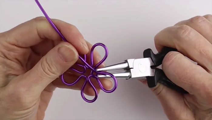 Assemble the flower: Bring all petals together, adjusting their positions. Secure using a ring cone to twist the wire several times, cut and tuck the excess wire.