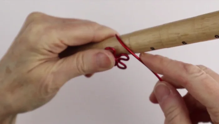 Finish the flower ring: Use the ring cone to secure the wire, and adjust the petals and center loop. Tuck excess wire into the ring.