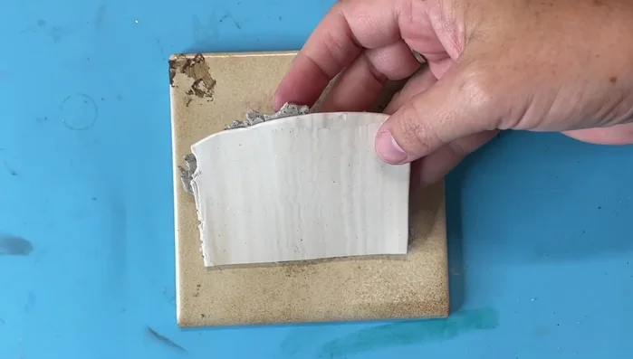 Lightly attach the clay to a small tile for baking.
