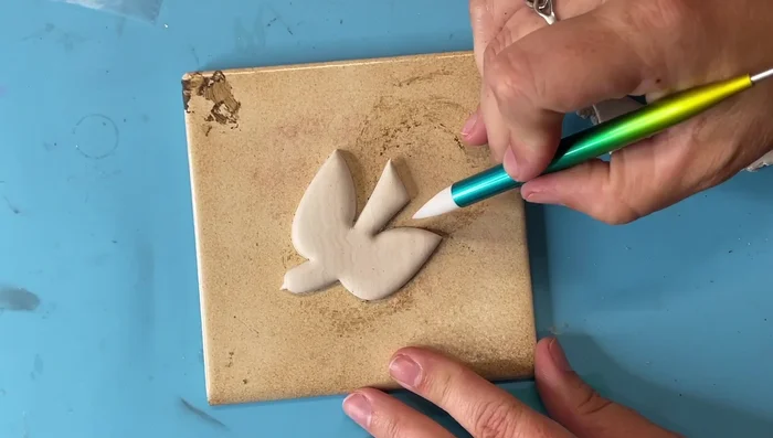 Clean up excess clay around the bird shape.