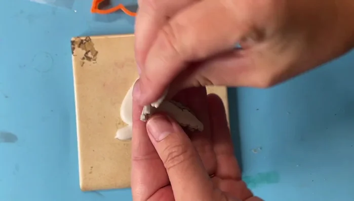 Apply the copper leafed clay around the edges of the bird.