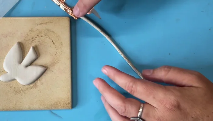 Apply the copper leafed clay around the edges of the bird.